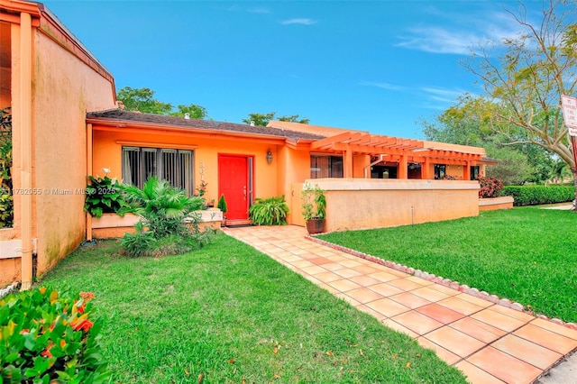 861 NW 79th Ter, Plantation, FL 33324 - view of front of house featuring a front yard, a pergola, and stucco siding
