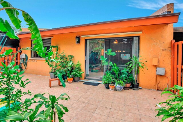 861 NW 79th Ter, Plantation, FL 33324 - property entrance with a patio area and stucco siding