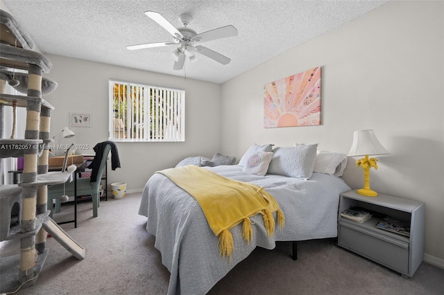 bedroom featuring baseboards, carpet floors, a textured ceiling, and ceiling fan