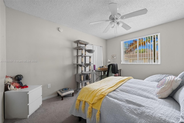 carpeted bedroom with ceiling fan, baseboards, and a textured ceiling