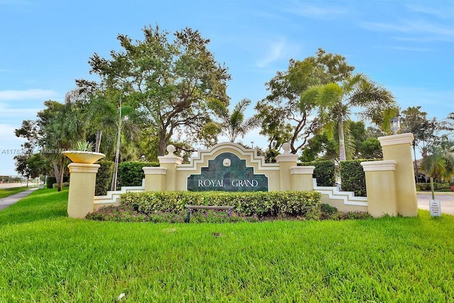 community / neighborhood sign with a yard