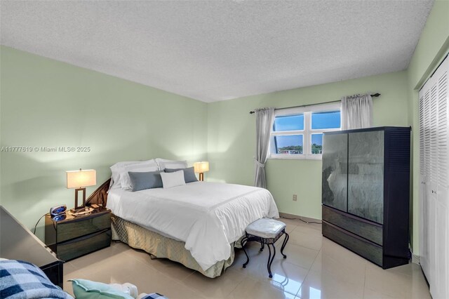 300 NW 107th Ave Unit 201, Miami, FL 33172 - bedroom with a textured ceiling and tile patterned flooring