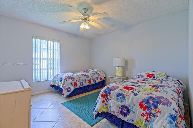 bedroom featuring ceiling fan, a textured ceiling, baseboards, and light tile patterned flooring