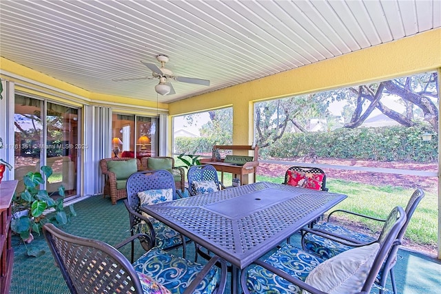 sunroom featuring outdoor dining space and ceiling fan