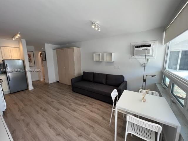 4228 N Ocean Dr Unit 17, Lauderdale By The Sea, FL 33308 - living room with light wood-style flooring and a wall unit AC