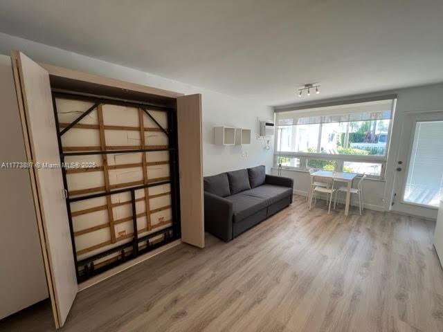 4228 N Ocean Dr Unit 17, Lauderdale By The Sea, FL 33308 - living room featuring a wall unit AC and wood finished floors