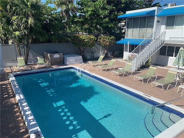 4228 N Ocean Dr Unit 17, Lauderdale By The Sea, FL 33308 - community pool featuring stairway, fence, a patio, and a sunroom