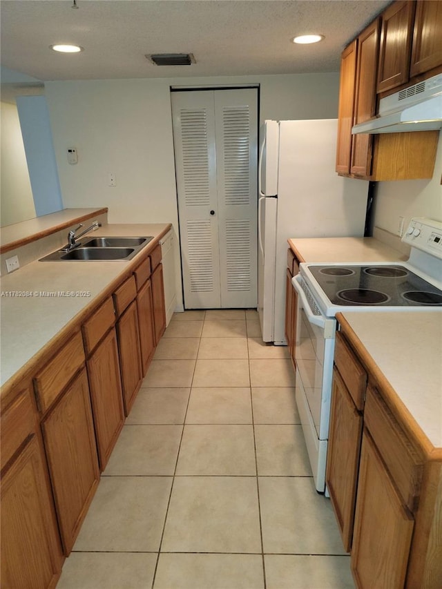 kitchen featuring light tile patterned floors, a sink, light countertops, under cabinet range hood, and white electric range
