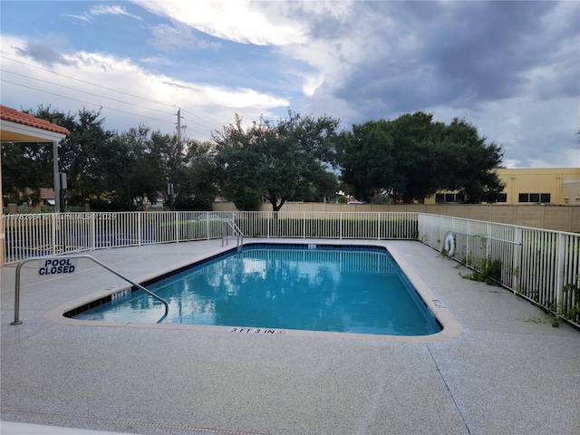pool featuring a patio and a fenced backyard