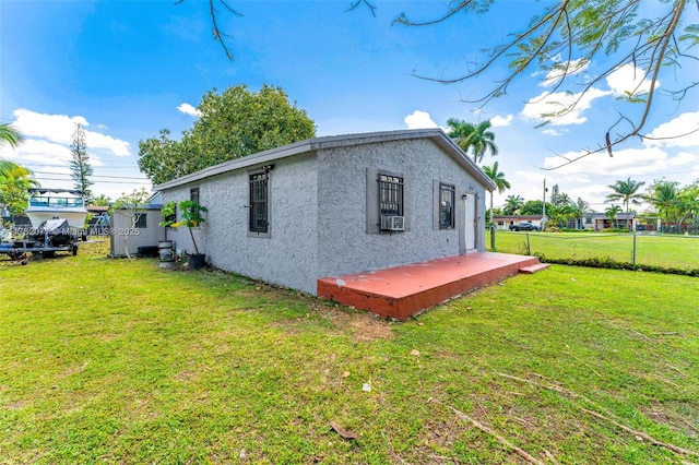 425 NW 8th Ave, Homestead, FL 33030 - view of property exterior featuring a yard, stucco siding, cooling unit, and fence
