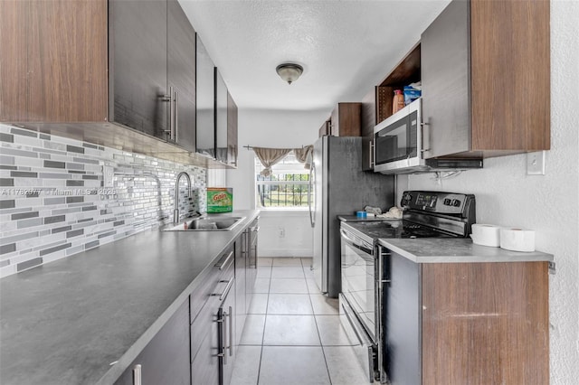 425 NW 8th Ave, Homestead, FL 33030 - kitchen with tasteful backsplash, light tile patterned floors, a sink, electric stove, and stainless steel microwave