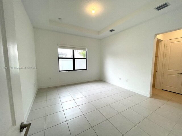 4506 SW 174th Ave, Miramar, FL 33029 - empty room with visible vents, baseboards, a raised ceiling, and light tile patterned floors
