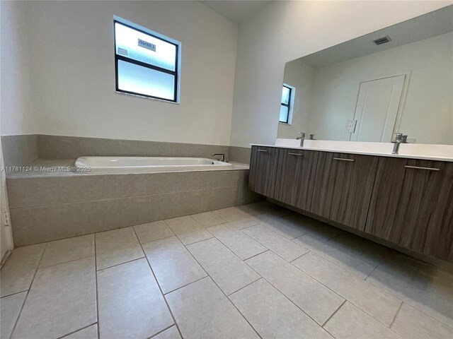 4506 SW 174th Ave, Miramar, FL 33029 - full bathroom featuring a sink, double vanity, tile patterned flooring, visible vents, and a garden tub