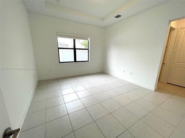4506 SW 174th Ave, Miramar, FL 33029 - unfurnished room with a tray ceiling, light tile patterned floors, baseboards, and visible vents