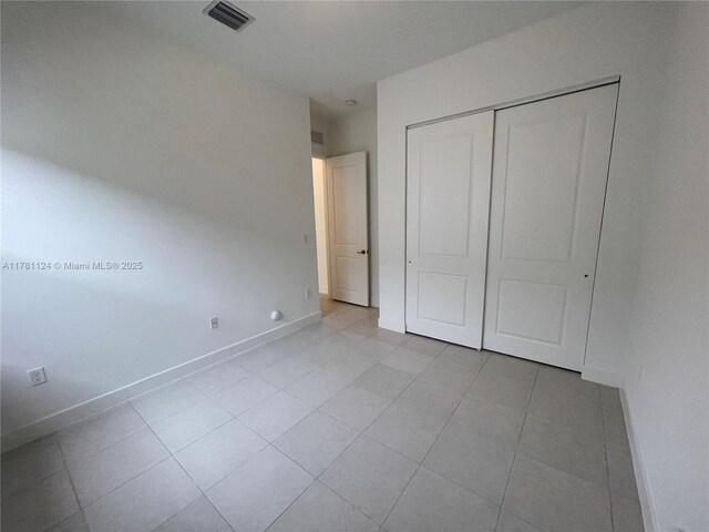 4506 SW 174th Ave, Miramar, FL 33029 - unfurnished bedroom featuring a closet, light tile patterned flooring, baseboards, and visible vents
