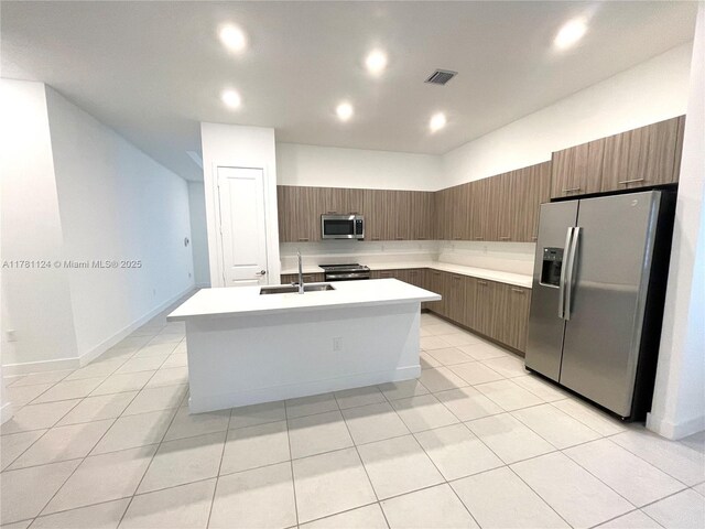 4506 SW 174th Ave, Miramar, FL 33029 - kitchen featuring an island with sink, visible vents, light countertops, a sink, and stainless steel appliances