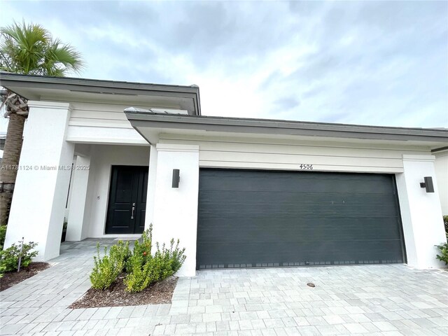 4506 SW 174th Ave, Miramar, FL 33029 - view of front facade with a garage, stucco siding, and decorative driveway
