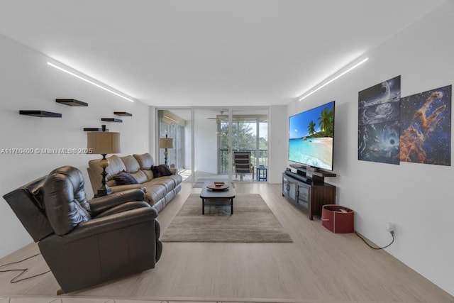 living room with wood finished floors and expansive windows