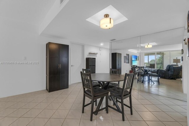 dining area featuring light tile patterned flooring