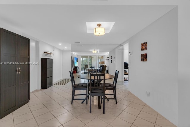 dining space featuring recessed lighting and light tile patterned floors