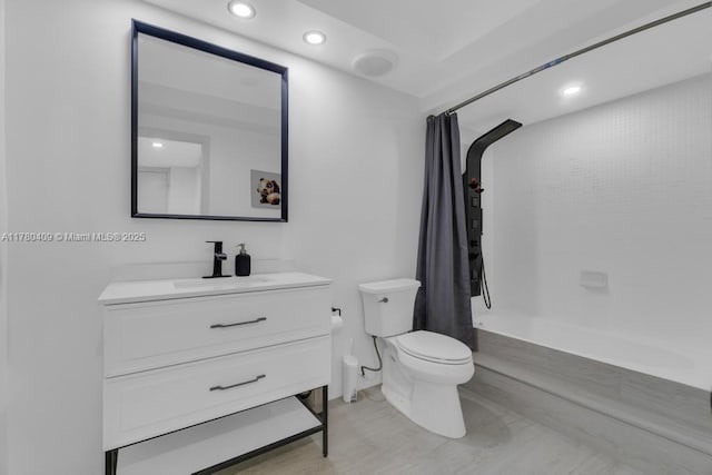 full bathroom featuring toilet, recessed lighting, vanity, and shower / bath combination with curtain