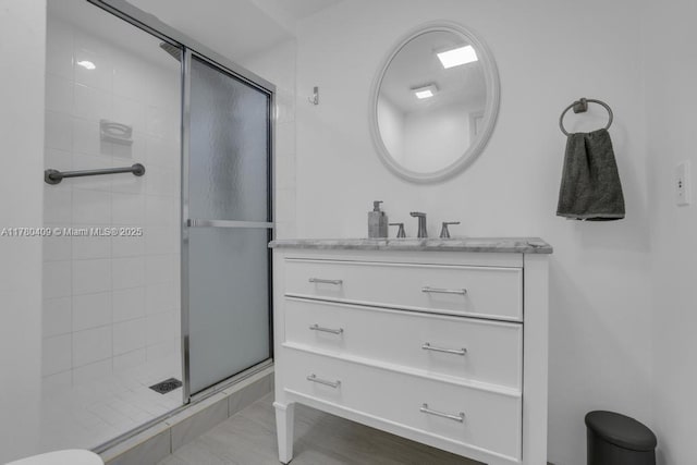 full bathroom featuring a shower stall and vanity