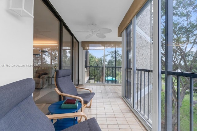 sunroom featuring ceiling fan