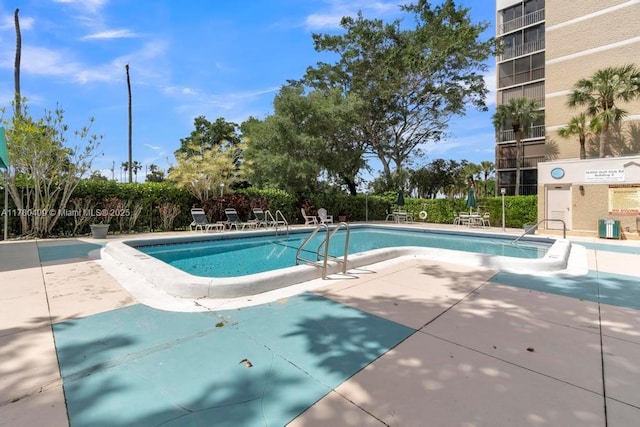 community pool with a patio area