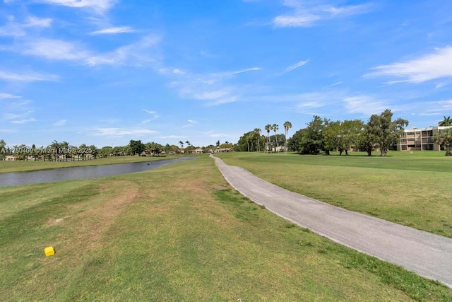 view of home's community with a lawn and a water view