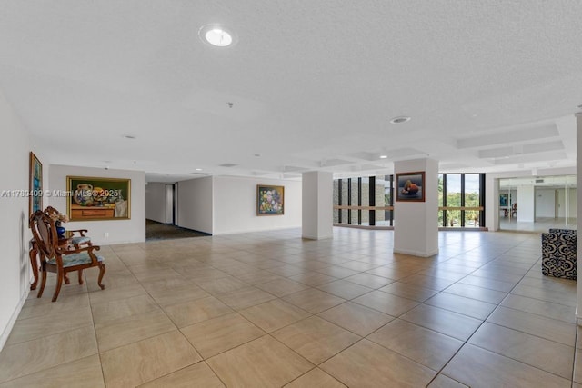 interior space with a textured ceiling and light tile patterned floors