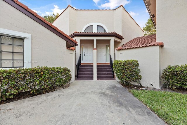 9239 W Sunrise Blvd, Plantation, FL 33322 - property entrance with stucco siding and a tile roof