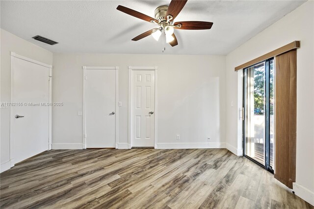 9239 W Sunrise Blvd, Plantation, FL 33322 - unfurnished bedroom with visible vents, access to exterior, baseboards, and wood finished floors