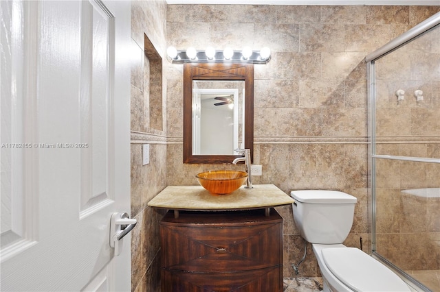 9239 W Sunrise Blvd, Plantation, FL 33322 - full bath featuring tiled shower, vanity, tile walls, and toilet