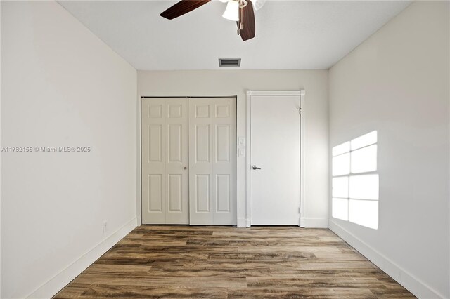 9239 W Sunrise Blvd, Plantation, FL 33322 - unfurnished bedroom featuring visible vents, a closet, baseboards, and wood finished floors