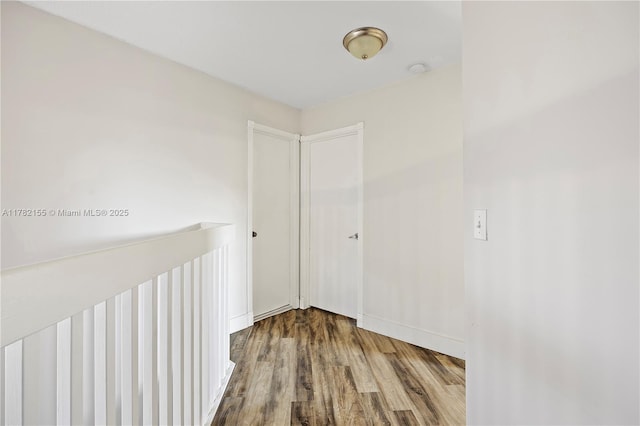 9239 W Sunrise Blvd, Plantation, FL 33322 - hallway with baseboards, an upstairs landing, and wood finished floors