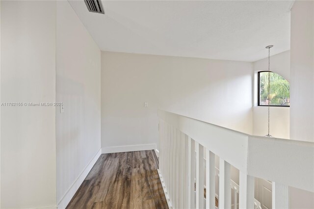9239 W Sunrise Blvd, Plantation, FL 33322 - hallway featuring visible vents, dark wood-style flooring, and baseboards