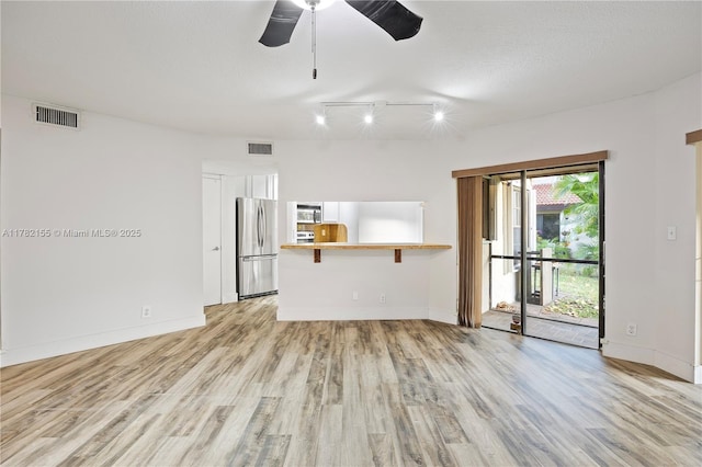 9239 W Sunrise Blvd, Plantation, FL 33322 - unfurnished living room featuring baseboards, rail lighting, a ceiling fan, light wood-style floors, and visible vents