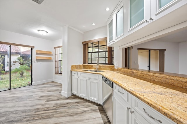9239 W Sunrise Blvd, Plantation, FL 33322 - kitchen with white cabinets, light wood-style floors, dishwasher, and a sink