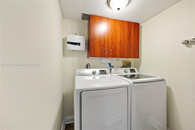 9239 W Sunrise Blvd, Plantation, FL 33322 - laundry room with washer and dryer, visible vents, a textured ceiling, and cabinet space