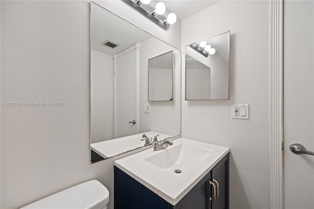 9239 W Sunrise Blvd, Plantation, FL 33322 - half bathroom with visible vents, toilet, and vanity
