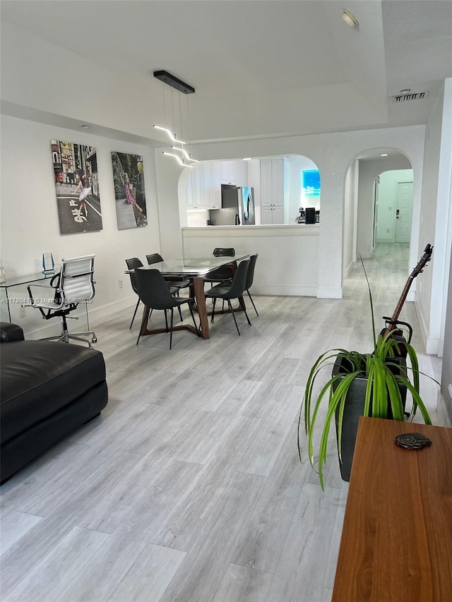 10770 NW 66th St Unit 203, Doral, FL 33178 - living room featuring baseboards, light wood finished floors, and arched walkways