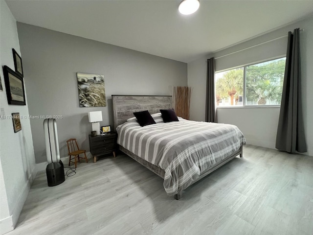 10770 NW 66th St Unit 203, Doral, FL 33178 - bedroom featuring light wood-type flooring and vaulted ceiling