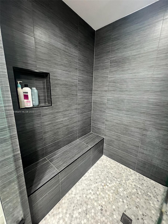 bathroom with a tile shower