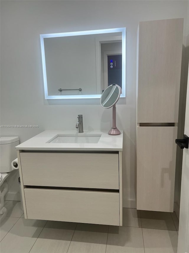 bathroom featuring tile patterned floors, vanity, and toilet