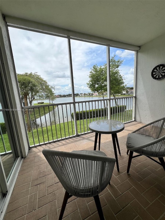 sunroom / solarium with a water view