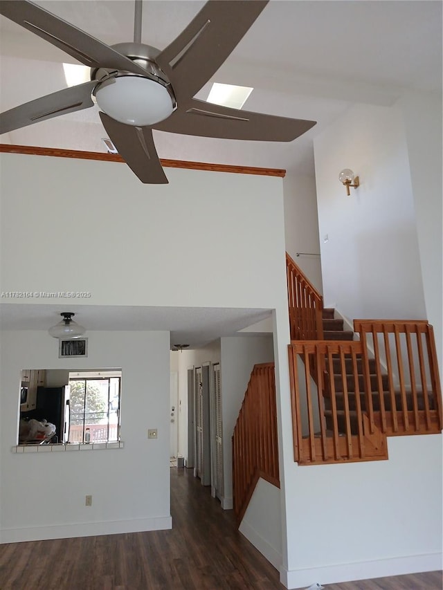 living room with high vaulted ceiling, ceiling fan, visible vents, stairs, and dark wood-style floors