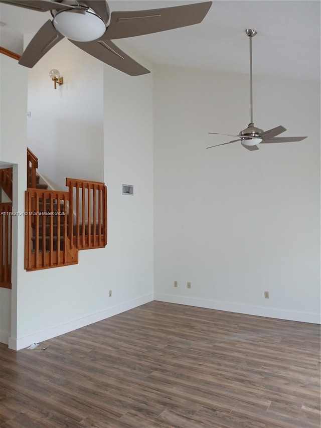 unfurnished living room with wood finished floors, baseboards, a ceiling fan, and visible vents