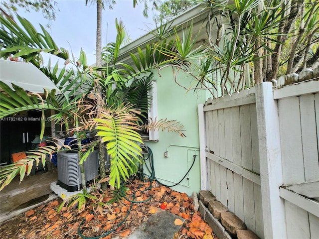 exterior details featuring fence and central AC unit