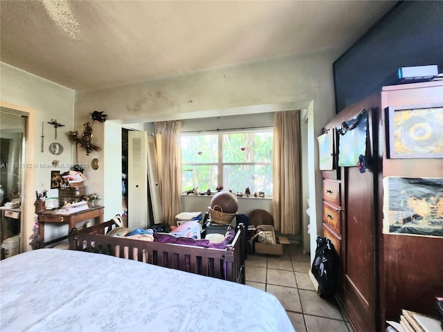 bedroom featuring light tile patterned floors and a closet