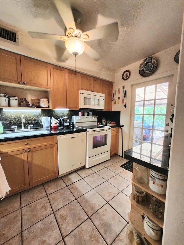 kitchen with tasteful backsplash, open shelves, a sink, visible vents, and white appliances